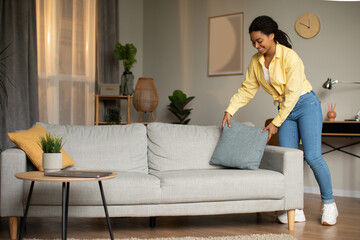 Black Lady Putting Decorative Pillow On Sofa Cleaning At Home