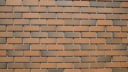 Brick wall made of facing bricks, close-up. Background for text. The wall is made of bricks. New style. Brick wall made of modern facing bricks.