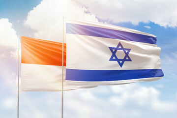 Sunny blue sky and flags of israel and indonesia