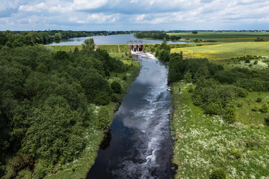 Aerial view of a small old dam on the river in summer