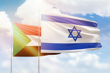 Sunny blue sky and flags of israel and sudan