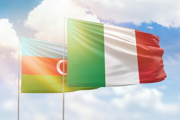 Sunny blue sky and flags of italy and azerbaijan