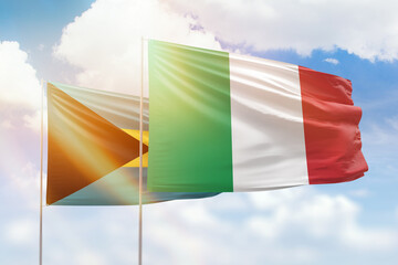 Sunny blue sky and flags of italy and bahamas