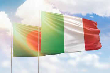 Sunny blue sky and flags of italy and bangladesh