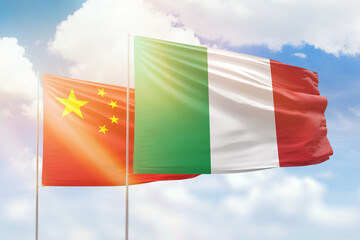 Sunny blue sky and flags of italy and china