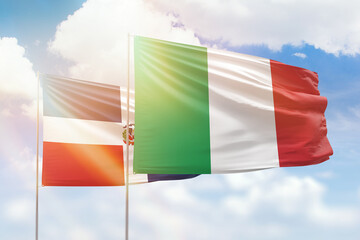 Sunny blue sky and flags of italy and dominican republic