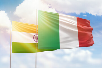 Sunny blue sky and flags of italy and india
