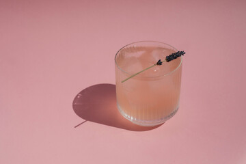 Fresh juicy cocktail on pink background.