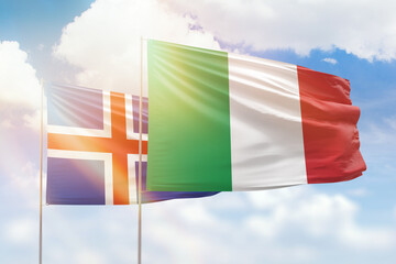 Sunny blue sky and flags of italy and iceland