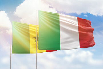 Sunny blue sky and flags of italy and senegal
