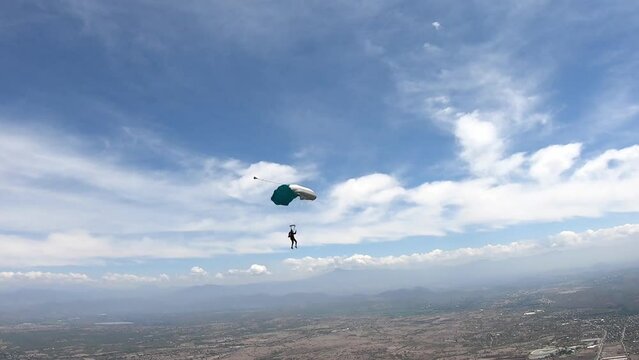 Skydiving. A solo parachute is flying in the sky.