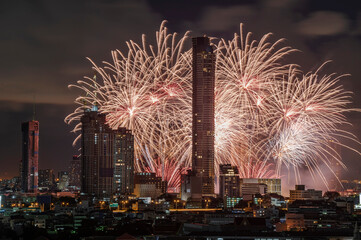 Fireworks in a cityscape at night with a metropolitan background