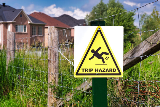 Selective focus of yellow trip hazard sign.