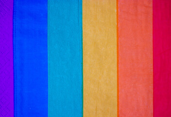 Abstract striped LGBT flag background texture. Textile or paper backdrop of rainbow bright colors. Vertical colorful stripes. Pride month concept. Holiday celebrating with gays, lesbians in June.
