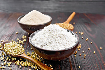 Flour buckwheat green and brown in bowls on wooden board