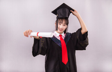 portrait of a young graduate holding a diploma