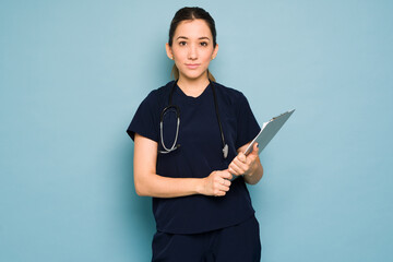 Portrait of a pretty Caucasian nurse wearing scrubs in a studio