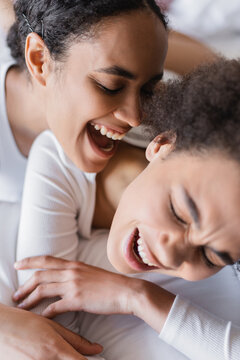 Excited African American Same Sex Couple Having Fun On Bed