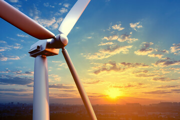 Wind turbine in front of cityscape. Installation for generating electricity. Wind turbine blades...