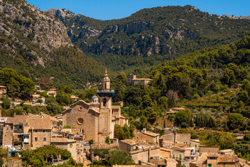 Fototapeta na wymiar Photograph of the church of the town of Valldemossa on the Island of Mallorca from a distance on a sunny day