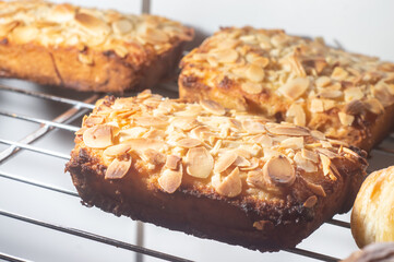 Bostocks with the addition of almond cream (frangipane) made of baked brioche slices, close up view. Traditional french sweet toast.
