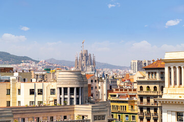 The Sagrada Familia Basilica seen from the rooftop of the Barcelona Cathedral on a summer day in the historic center of Barcelona, Spain. - obrazy, fototapety, plakaty