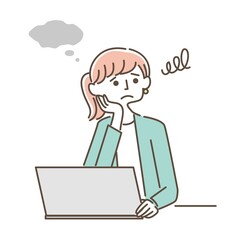 パソコンの前で悩むスーツの女性