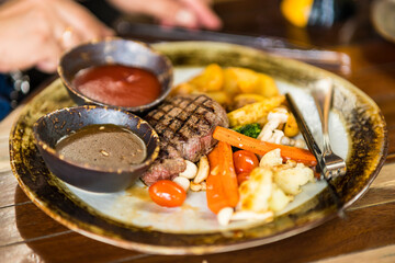 Delicious beef medallions served on table