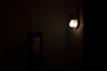 Fototapeta na wymiar Light bulb by vintage phone
