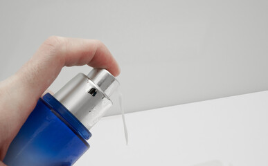 finger presses cosmetic skin care bottle