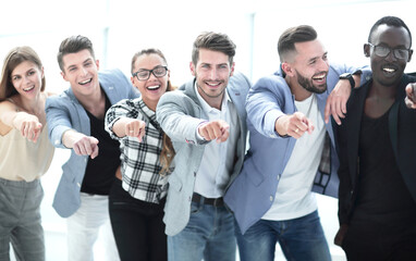 Group of people pointing at the camera and smiling - isolated