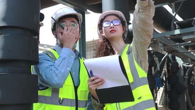 Engineer under checking the industry chilled water fan coil unit air conditioner is water cooling tower air chiller HVAC system of large industrial building to control air system