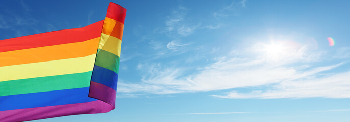 Rainbow flag on sky background. LGBT concept.