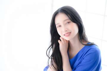 Fototapeta premium Woman grooming hair, looking at camera