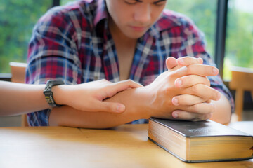 Christian Praying on open Bible.