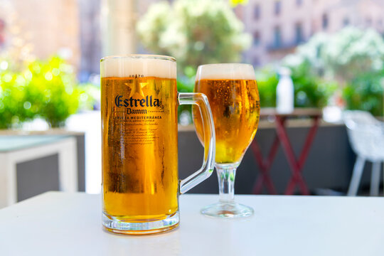 General view of a large glass of Estrella Damm beer on a table at an outdoor cafe in Barcelona, Spain on June 2 2022.