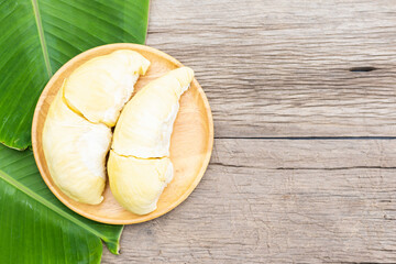Durian fruit on wooden dish on wood table with copy space