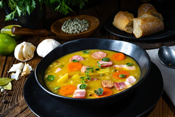 Hearty rustic pea soup with bacon and sausage