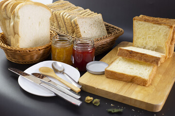 bread, butter and jam on desk.