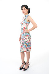 Portrait of a young asian Chinese female lady model wearing a patterned traditional vintage costume Cheongsam smiling and posing with different poses and gestures 