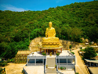 Ariel view Golden Buddha statue's hand holding lotus at Chon Khong Monastery which attracts...