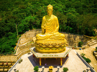 Ariel view Golden Buddha statue's hand holding lotus at Chon Khong Monastery which attracts...