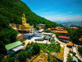 Ariel view Golden Buddha statue's hand holding lotus at Chon Khong Monastery which attracts...