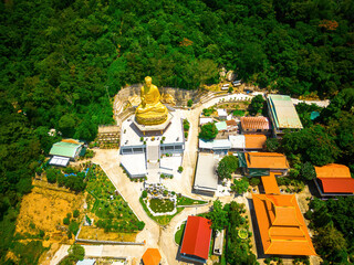 Ariel view Golden Buddha statue's hand holding lotus at Chon Khong Monastery which attracts...