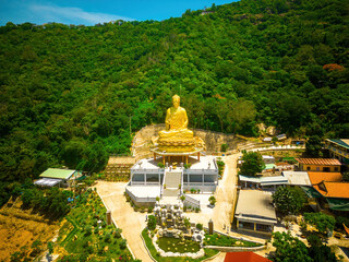 Ariel view Golden Buddha statue's hand holding lotus at Chon Khong Monastery which attracts...