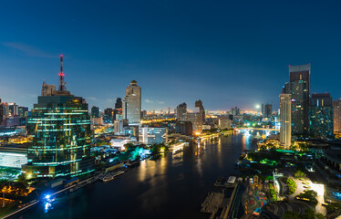 Chao Phraya River with Taksin bridge and building of Bangkok city at night, Thailand