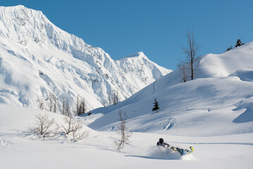 Fototapeta na wymiar Snowmachine rider in Alaska backcountry