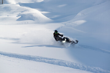 Snowmachine rider in Alaska backcountry