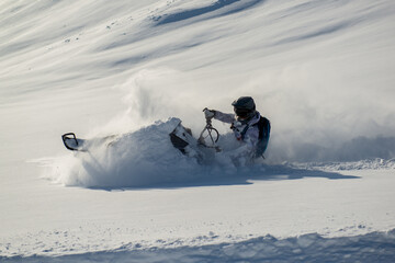Snowmachine rider in Alaska backcountry