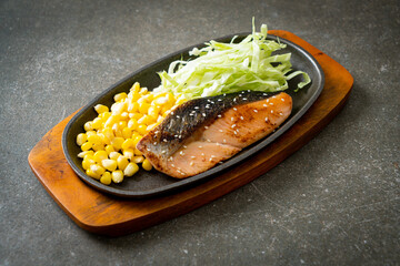 grilled salmon fillet steak on hot plate